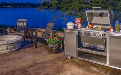 Silver Rocket Grill on a patio beside a lake